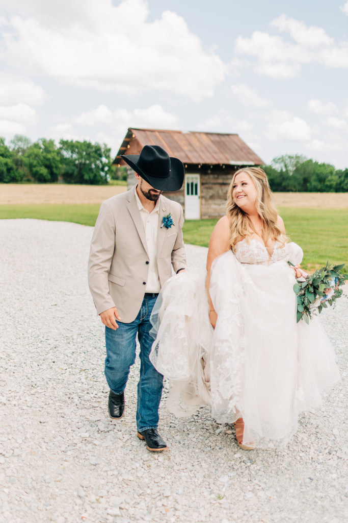 bride and groom walk together laughing