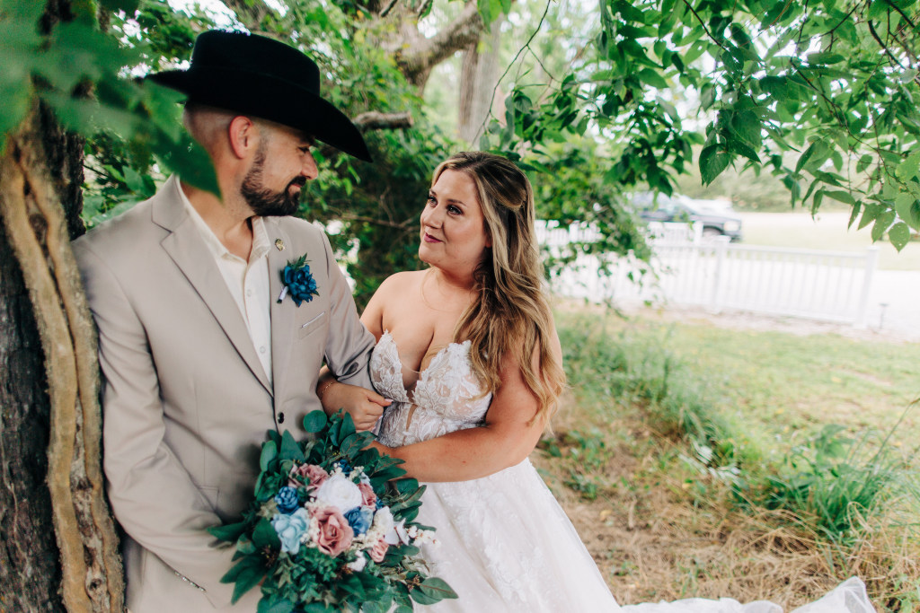 bride and groom gaze at each other in the shade of a tree at the White Barn in Hasty
