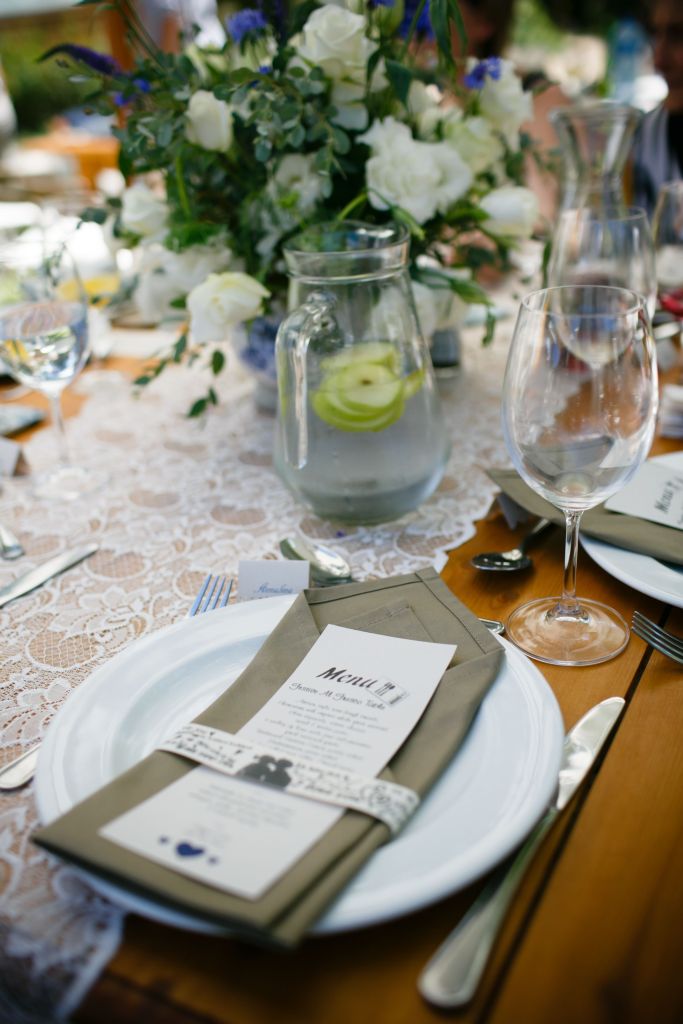 elegant table setting with lace trim and a garden-style white rose bouquet in the center